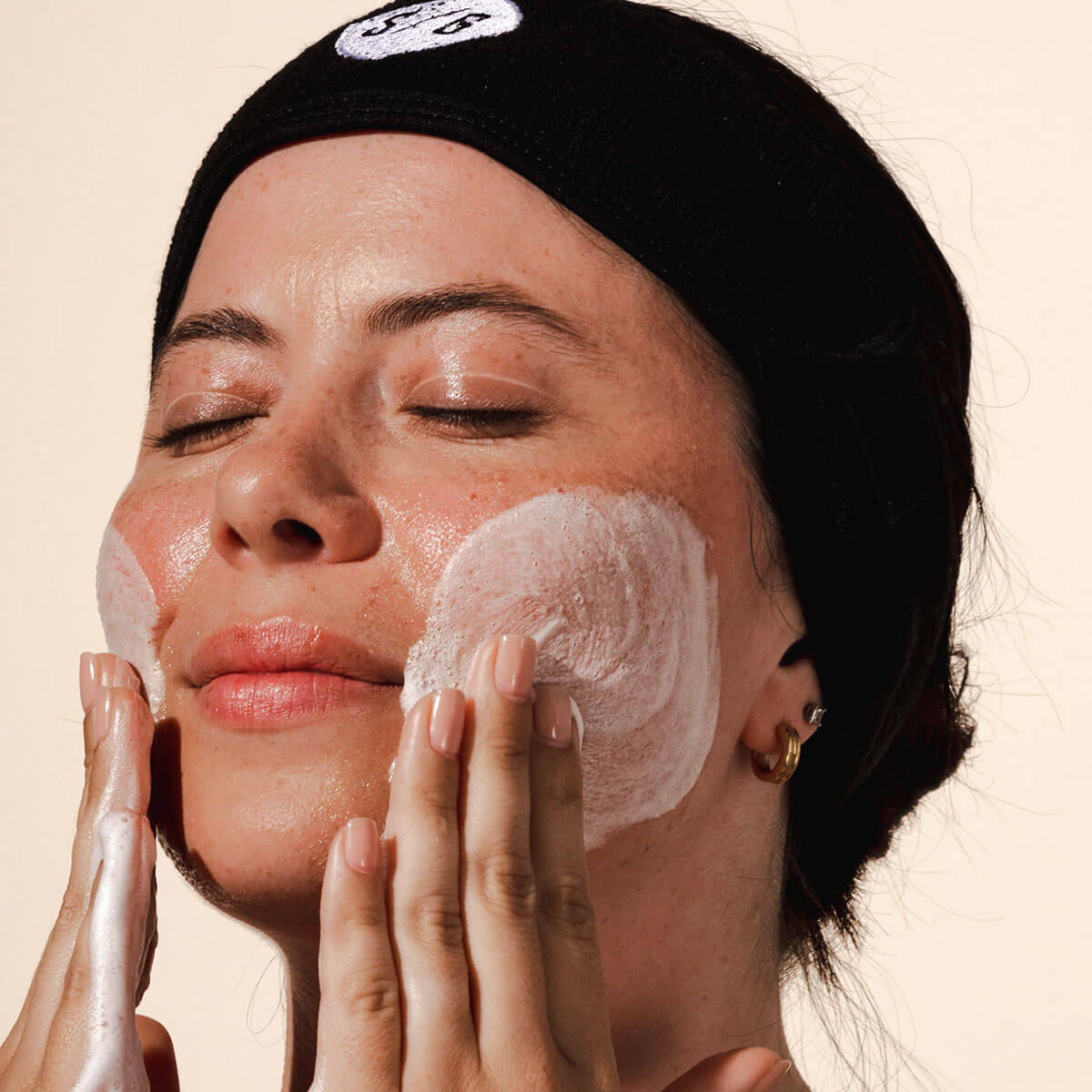 woman cleaning her face