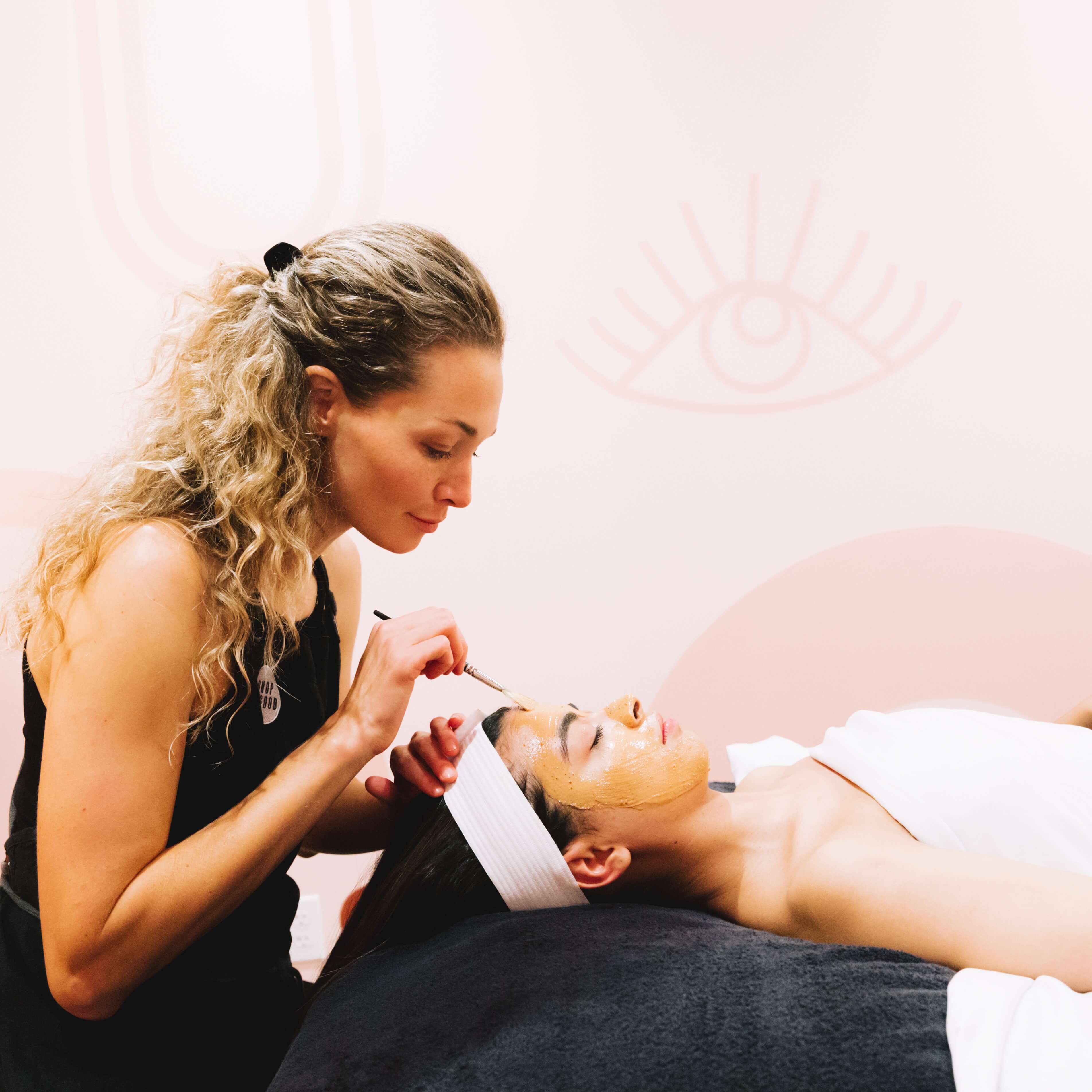 Master esthetician performing a facial treatment at Shop Good spa in San Diego