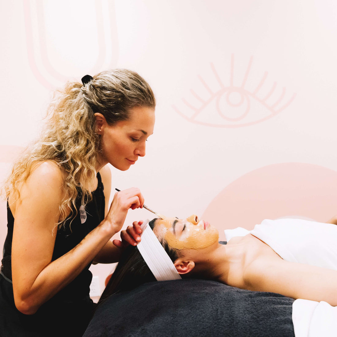Master esthetician performing a facial treatment at Shop Good spa in San Diego