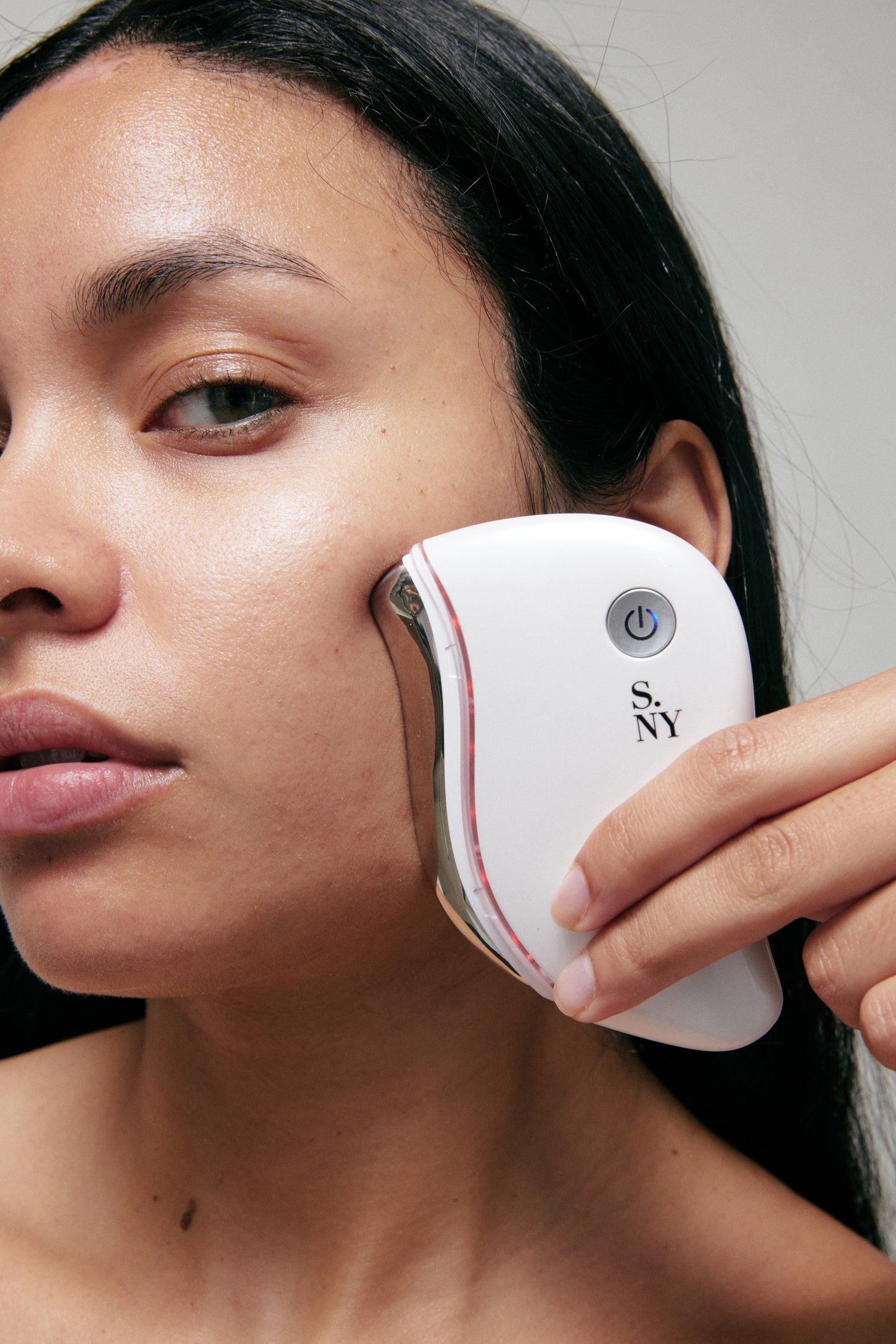 woman with LED gua sha