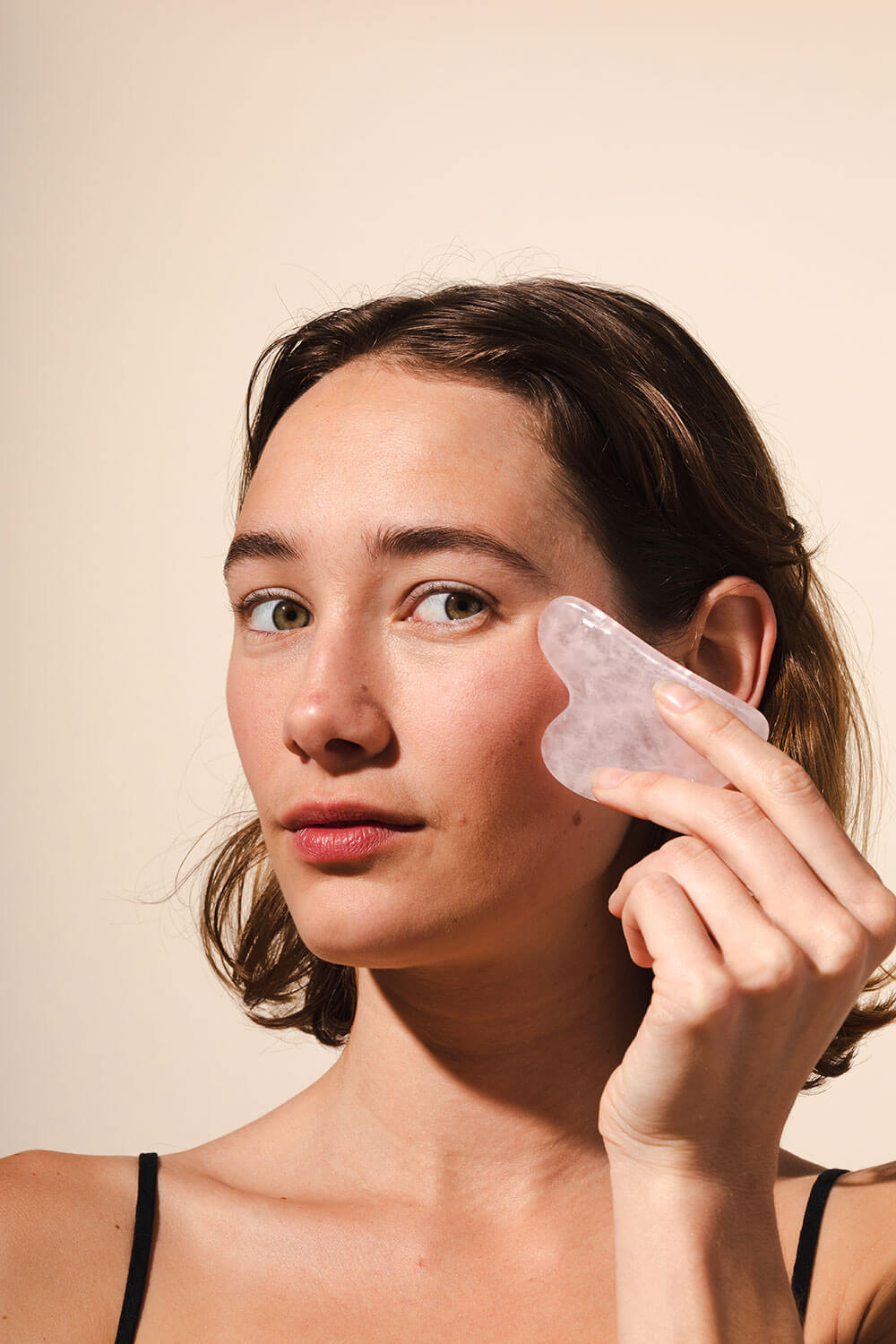 woman with facial tool