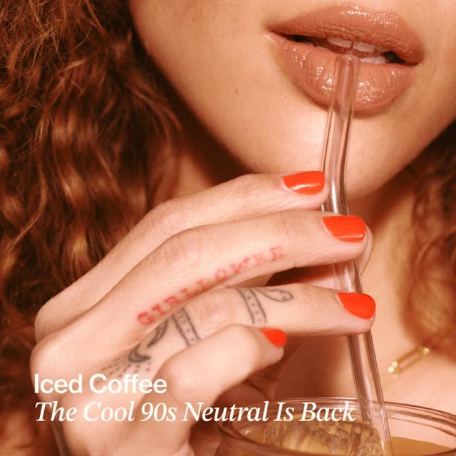 Close-up of a person drinking iced coffee with text overlay.