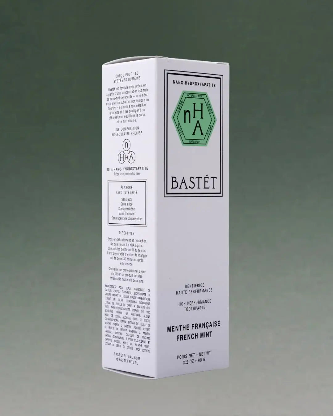 A tall white rectangular box of Bastét Nana Hydrogenated Toothpaste, French Mint flavor, shown on a dark green gradient background.