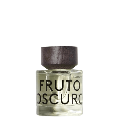 A bottle of Fruto Oscuro Eau de Vie fragrance with a dark brown wooden cap and clear glass bottle showing a light amber liquid, set against a plain white background.