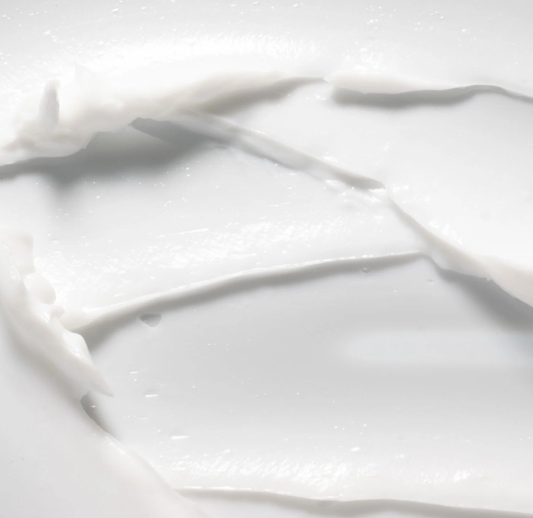 Close-up of white fabric with folds on a light gray background