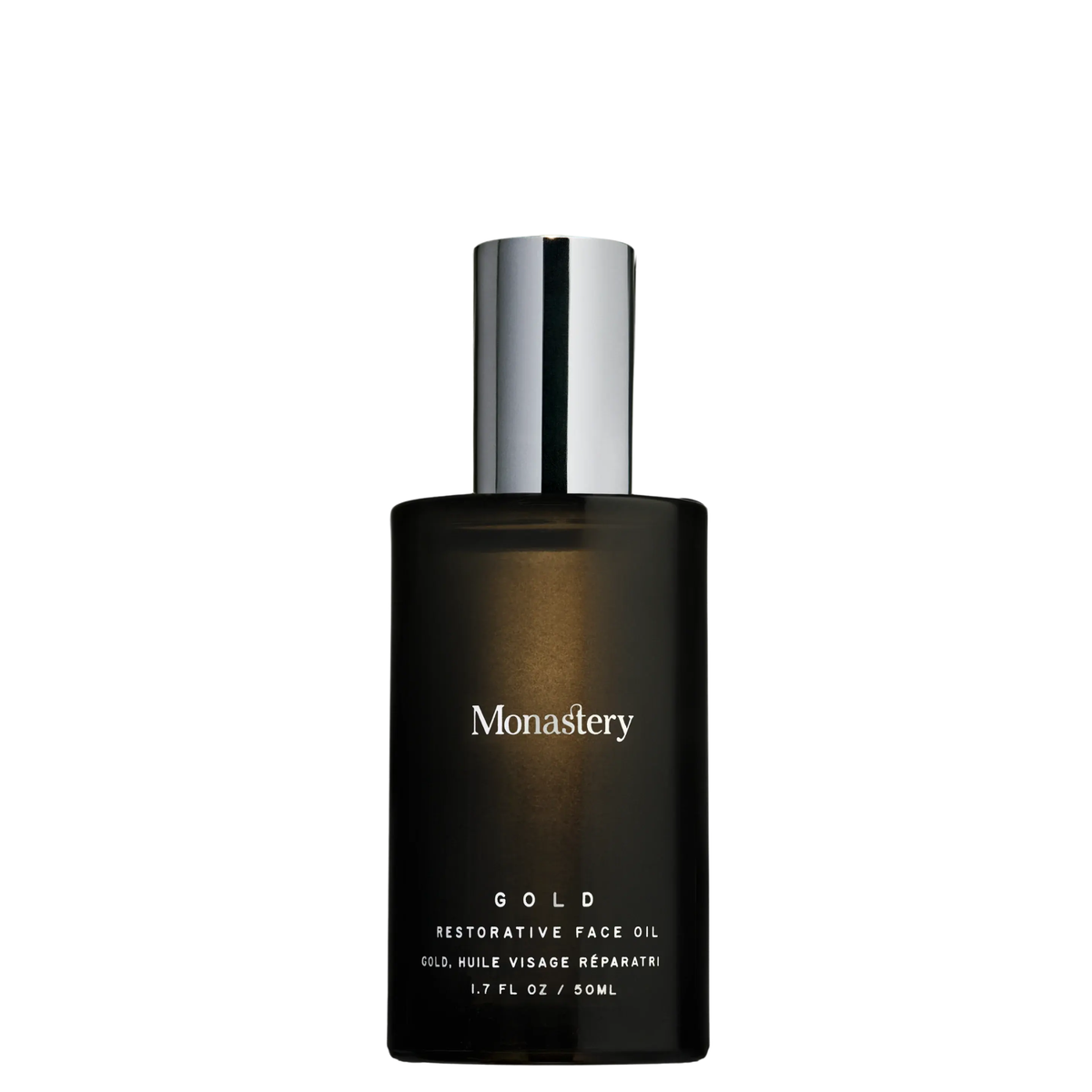 Monastery Gold Restorative Face Oil in a dark amber glass bottle with a reflective silver cap, shown on a plain white background.