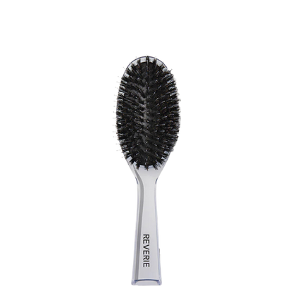 Hairbrush with black bristles and silver handle on a white background