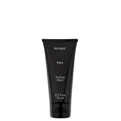 A black squeeze tube of REVERIE Rake Styling Balm, 2.5 fl oz (74 ml), shown against a plain white background.