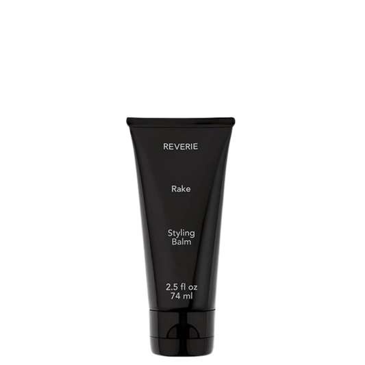 A black squeeze tube of REVERIE Rake Styling Balm, 2.5 fl oz (74 ml), shown against a plain white background.