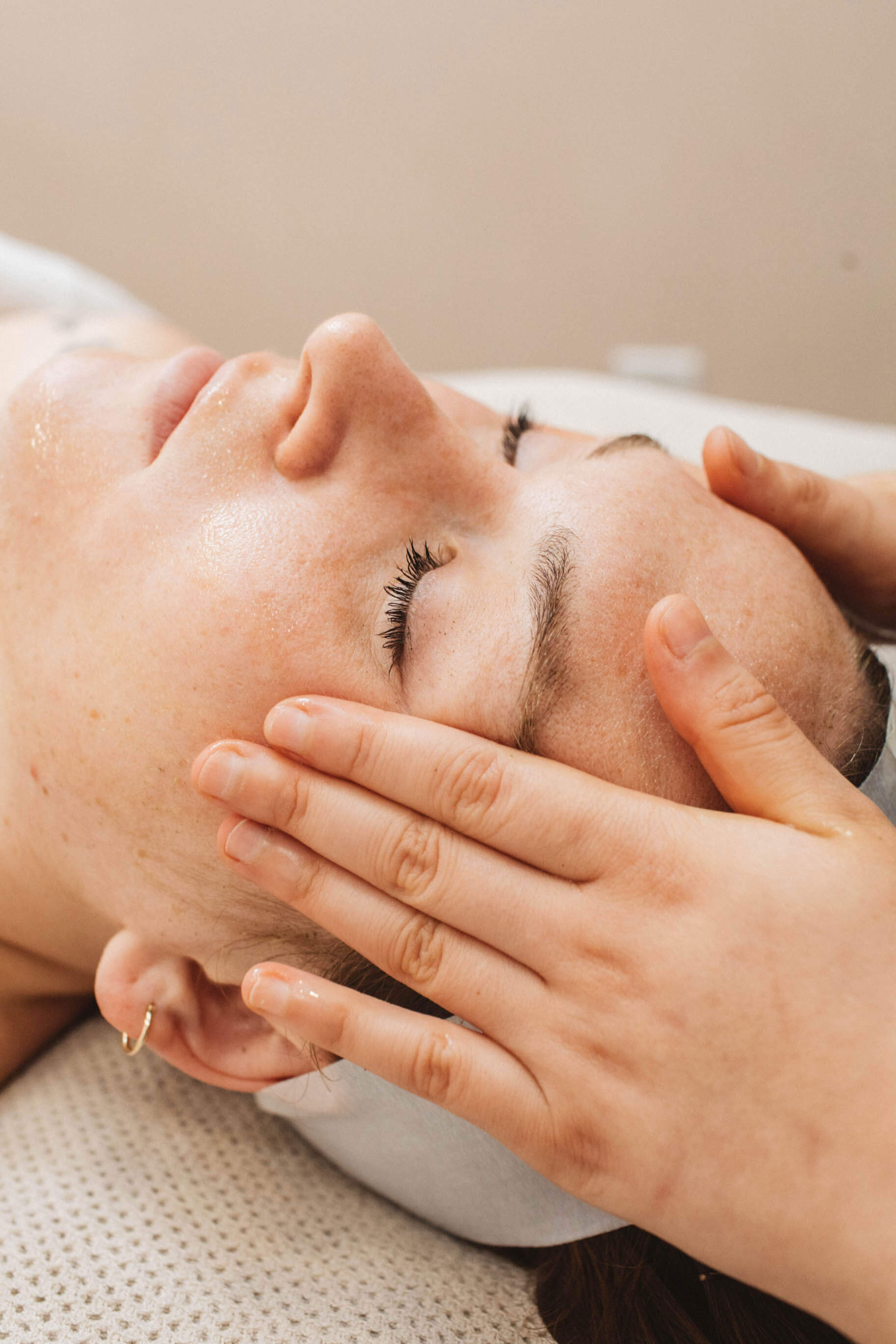 woman getting facial massage at shop good