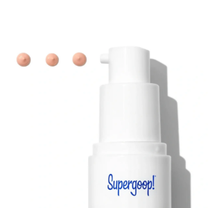 white supergoop bottle with dots of product