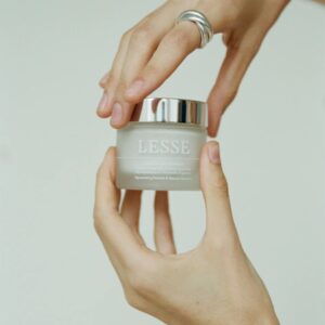 moisturizer jar in hands