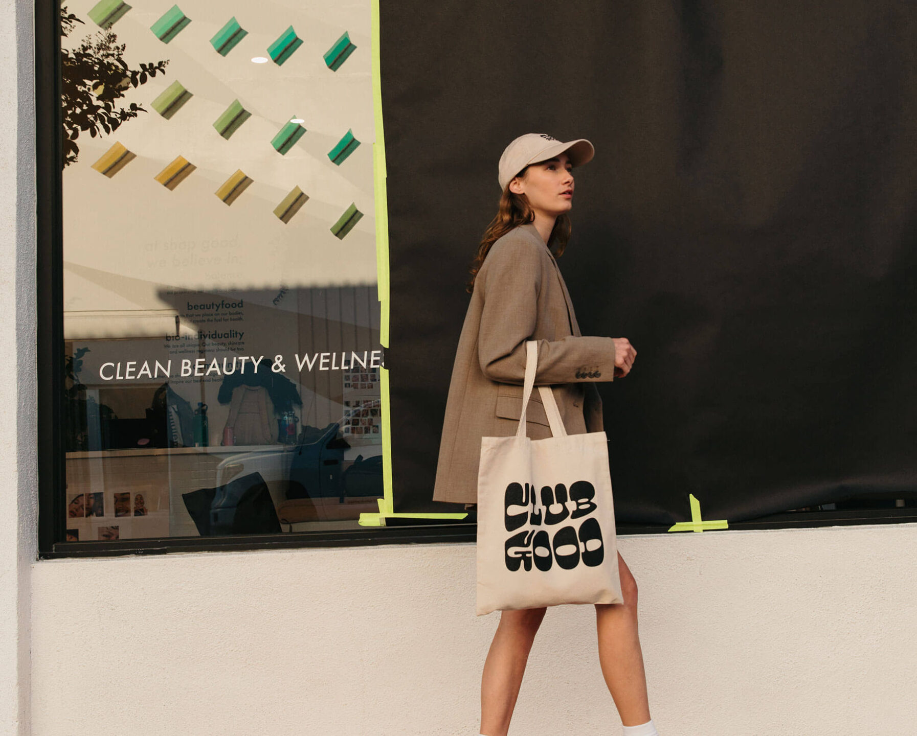 woman walking with Club Good bag